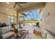 A screened in living space with comfortable lounge chairs and coffee table overlooking the pool at 3904 Waypoint Ave, Osprey, FL 34229