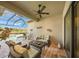 Relaxing covered patio area with comfortable seating, ceiling fan, and views of the pool at 3904 Waypoint Ave, Osprey, FL 34229
