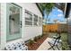 Inviting backyard patio with ample seating, lush greenery, and a charming white-washed exterior at 4536 1St N Ave, St Petersburg, FL 33713