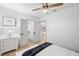 Bedroom with a walk-in closet features wood-look flooring and white trim at 4536 1St N Ave, St Petersburg, FL 33713