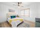 Bright bedroom features neutral walls, wood-look flooring, and a modern ceiling fan at 4536 1St N Ave, St Petersburg, FL 33713