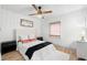 Bright bedroom features neutral walls, wood-look flooring, ceiling fan, and modern furnishings at 4536 1St N Ave, St Petersburg, FL 33713