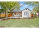 Inviting craftsman home featuring a cozy front porch with wooden pillars, lush lawn, and professional landscaping at 4536 1St N Ave, St Petersburg, FL 33713