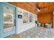 Inviting front porch with patterned tile, wood ceiling, and seating creates a cozy outdoor space at 4536 1St N Ave, St Petersburg, FL 33713