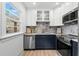 Modern kitchen features navy cabinets, marble backsplash, stainless steel appliances and a bright window at 4536 1St N Ave, St Petersburg, FL 33713