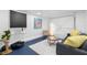 Cozy living room features a sleek couch, modern rug, and painted concrete floors at 4536 1St N Ave, St Petersburg, FL 33713