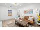 Sunlit living room featuring a comfortable sofa, contemporary lighting, and elegant hardwood floors at 4536 1St N Ave, St Petersburg, FL 33713