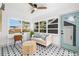 Bright sitting room features a patterned tile floor, white walls, and many windows at 4536 1St N Ave, St Petersburg, FL 33713