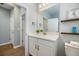 Well-lit bathroom featuring modern vanity, decorative mirror, and neutral color palette at 6077 Amberly Dr, Bradenton, FL 34208
