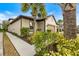 Beige home exterior showcases a lush landscaped yard, enhancing its curb appeal at 6077 Amberly Dr, Bradenton, FL 34208