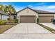 Home featuring a large concrete driveway and a well-maintained front lawn at 6077 Amberly Dr, Bradenton, FL 34208