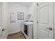 Clean laundry room with washer, dryer, shelving, and white walls at 6077 Amberly Dr, Bradenton, FL 34208