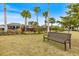 Community park featuring a bench, palm trees, grassy area, and clubhouse with an outdoor pool at 6077 Amberly Dr, Bradenton, FL 34208