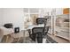 Home office with a white desk, shelves and white furniture, with a view into the connected living space at 6702 Pinehurst Pl, Bradenton, FL 34202