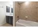 Bathroom with combined bathtub and shower with beige tiling at 8402 Grand Estuary Trl # 101, Bradenton, FL 34212