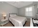 Cozy bedroom features natural light, ceiling fan, and neutral decor at 8402 Grand Estuary Trl # 101, Bradenton, FL 34212