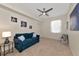Bright bedroom offers a cozy blue couch, ceiling fan, and neutral decor at 8402 Grand Estuary Trl # 101, Bradenton, FL 34212