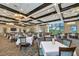 An elegant dining area showcases a light color palette, decorative lighting, and expansive windows with beautiful views at 8402 Grand Estuary Trl # 101, Bradenton, FL 34212