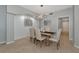 Elegant dining room featuring a rustic table, upholstered chairs, modern lighting, and stylish decor for intimate gatherings at 8402 Grand Estuary Trl # 101, Bradenton, FL 34212