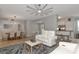 Open-concept living room with neutral decor, tile floors, and access to the dining area and kitchen for easy entertaining at 8402 Grand Estuary Trl # 101, Bradenton, FL 34212