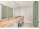 Modern bathroom featuring double sinks with marble countertops and a large mirror at 1155 N Gulfstream Ave # 607, Sarasota, FL 34236
