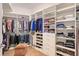 Organized walk-in closet with shelves, hanging rods, drawers, and an ottoman at 1155 N Gulfstream Ave # 607, Sarasota, FL 34236