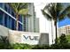 Exterior view of the Vue Sarasota Bay with palm trees and landscaping at 1155 N Gulfstream Ave # 607, Sarasota, FL 34236