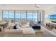 Inviting living room with floor-to-ceiling windows offering panoramic water views and ample natural light at 1155 N Gulfstream Ave # 607, Sarasota, FL 34236