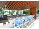 Upscale outdoor kitchen with bar seating, grill, and view of modern building at 1155 N Gulfstream Ave # 607, Sarasota, FL 34236