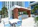 Modern outdoor kitchen with bar seating and table, perfect for entertaining next to pool at 1155 N Gulfstream Ave # 607, Sarasota, FL 34236