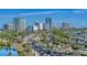 An urban street view showcases a street with heavy traffic, lined with buildings, trees, and palm trees at 1155 N Gulfstream Ave # 607, Sarasota, FL 34236