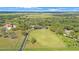 This aerial showcases the homes' idyllic location and the vast grassy acreage at 12001 Backwater Rd, Sarasota, FL 34240