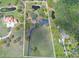 Expansive property with a long driveway, mature trees, pool, ponds, and a large home at 12001 Backwater Rd, Sarasota, FL 34240