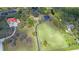 A bird's eye view highlighting the expansive land, pond, and neighborhood homes at 12001 Backwater Rd, Sarasota, FL 34240