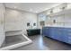 Modern bathroom with a black tub, a shower, and a blue vanity at 12001 Backwater Rd, Sarasota, FL 34240