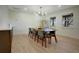 Bright dining room features wood floors, and stylish light fixture at 12001 Backwater Rd, Sarasota, FL 34240