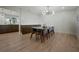 Dining room featuring wood floors, view to kitchen and modern lighting at 12001 Backwater Rd, Sarasota, FL 34240