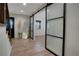 Bright entryway with modern sliding glass doors, wood floors, and natural light at 12001 Backwater Rd, Sarasota, FL 34240
