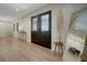 Welcoming foyer with double front doors, wood flooring, and modern accents at 12001 Backwater Rd, Sarasota, FL 34240