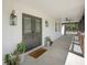 Elegant front porch with double doors, exterior lantern lights and ample space for seating at 12001 Backwater Rd, Sarasota, FL 34240