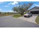 Two-story home with a long driveway and well-manicured lawn at 12001 Backwater Rd, Sarasota, FL 34240