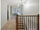 Hallway with wood floors and stairs, with neutral paint, and modern lighting at 12001 Backwater Rd, Sarasota, FL 34240