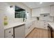 Clean kitchen design highlighting white cabinets, stainless steel appliances, and bright countertops and backsplash at 12001 Backwater Rd, Sarasota, FL 34240