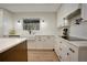 Updated kitchen showcasing white cabinets, modern backsplash, stainless steel appliances, and stone countertops at 12001 Backwater Rd, Sarasota, FL 34240