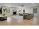 Spacious living room with a cozy fireplace, large sectional sofa, and bright natural light at 12001 Backwater Rd, Sarasota, FL 34240