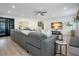 Comfortable living room featuring a fireplace, a large sectional sofa, and an open view of the kitchen at 12001 Backwater Rd, Sarasota, FL 34240