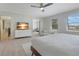 Spacious main bedroom with wood floors, a ceiling fan, and neutral colors throughout at 12001 Backwater Rd, Sarasota, FL 34240