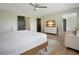 Bright main bedroom with wood floors, ceiling fan, dresser, and natural light from the windows at 12001 Backwater Rd, Sarasota, FL 34240