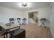 Open office space with wood floors, modern lighting, and view of the staircase at 12001 Backwater Rd, Sarasota, FL 34240