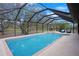 Screened in pool and hot tub with a view of the property's trees and landscaping at 12001 Backwater Rd, Sarasota, FL 34240